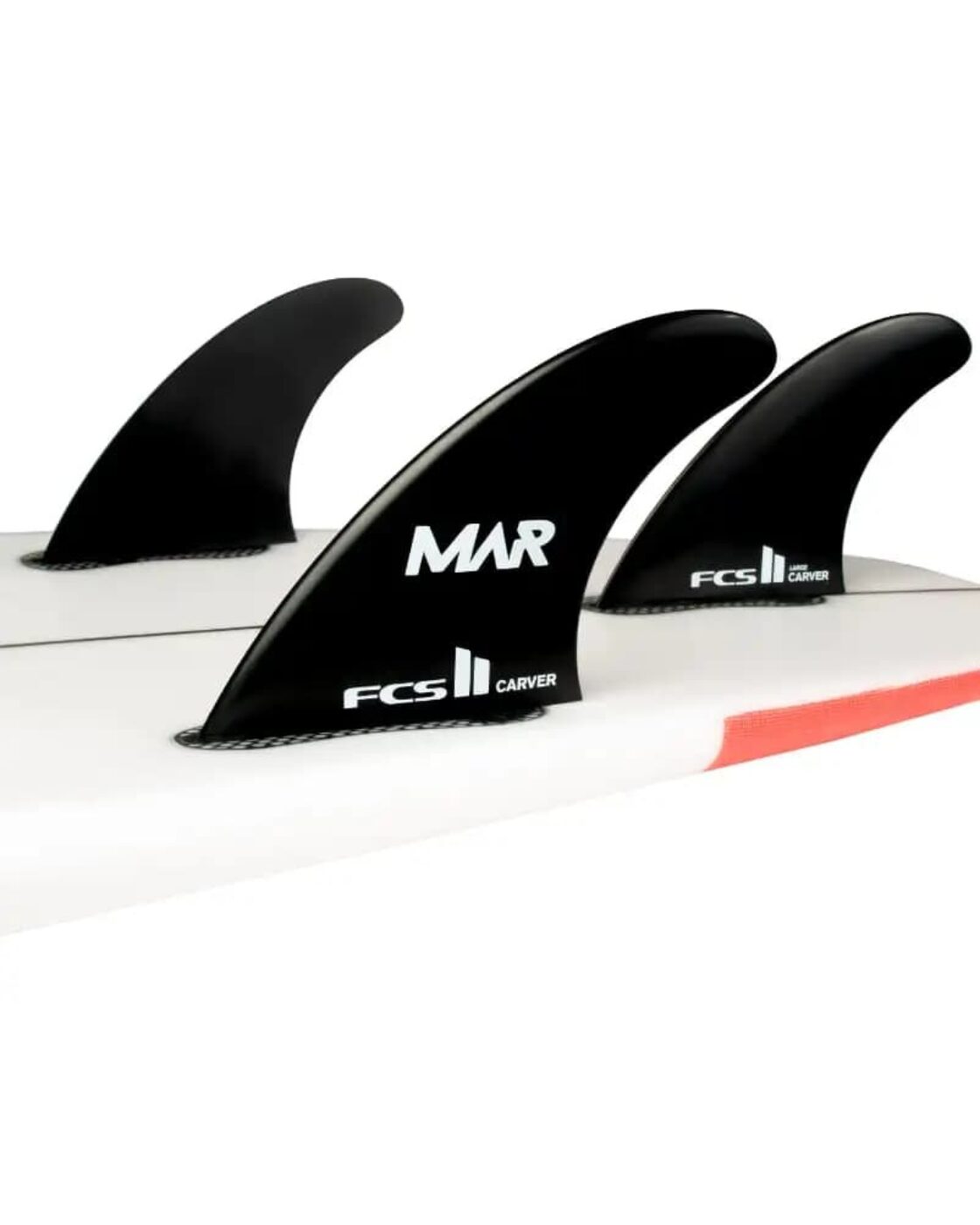 Close-up of black MAR FCS II surfboard fins mounted on a white surfboard.