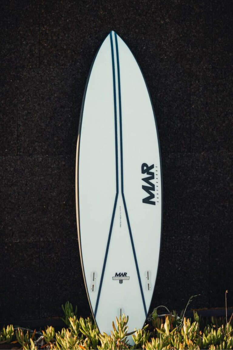 Mar Surfboards Parrot surfboard displayed against a dark textured wall